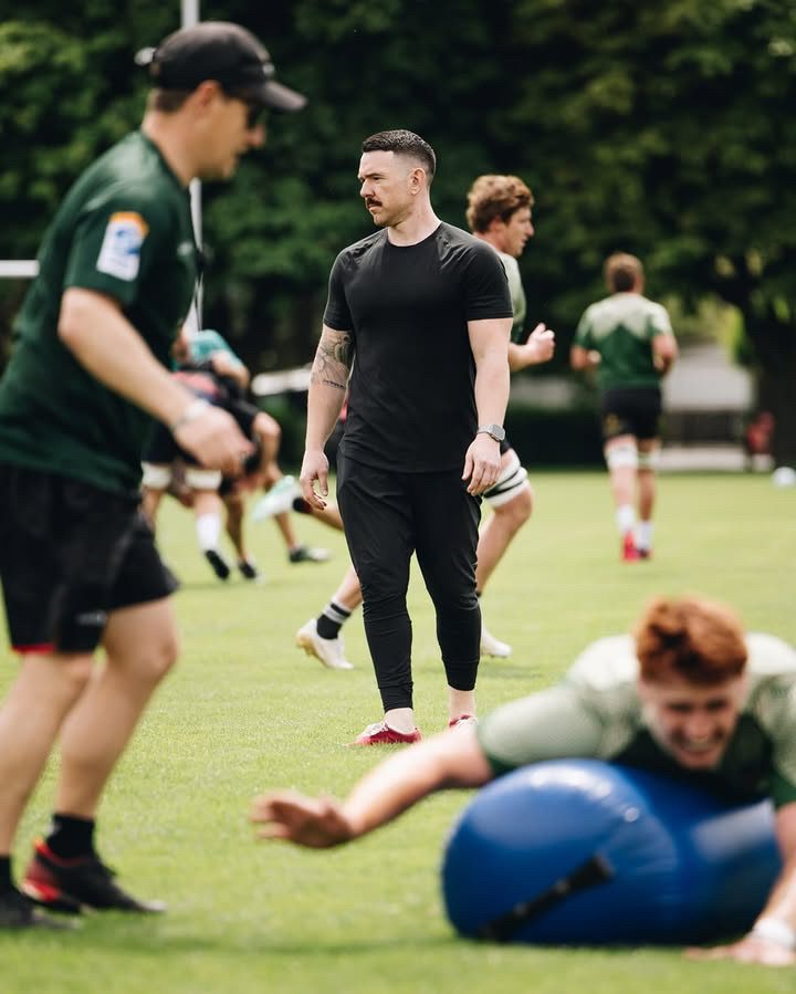 Jamie O'Donnell coaching on the field with Crusaders players
